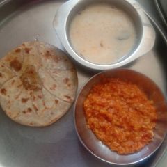 A picture of Gujarati famous puran poli and mograldal, kadhi.