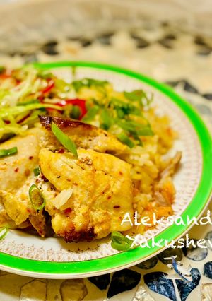 A picture of Chicken thighs with rice in the oven.