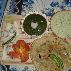 A picture of Bajra ke roti or saag with rayta or salad.