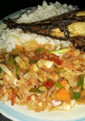 A picture of White rice with vegetable sauce and grilled titus fish.