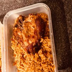 A picture of Jollof Rice with Grilled Chicken.