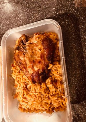 A picture of Jollof Rice with Grilled Chicken.