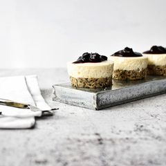 A picture of Mini No Bake Cheesecakes with Seeded Base and Blueberry Compote Topping.