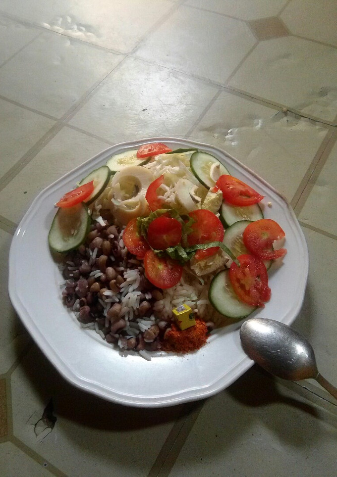 A picture of Rice nd beans with simple salad.