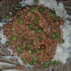 A picture of Minced meat and green peas stew served with rice.