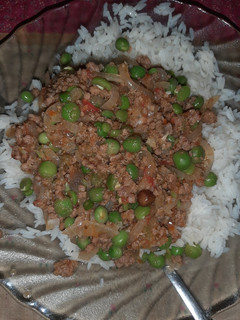 A picture of Minced meat and green peas stew served with rice.