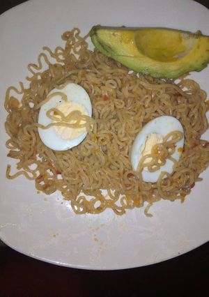 A picture of Cooked Indomie and Boiled eggs with Avocado.