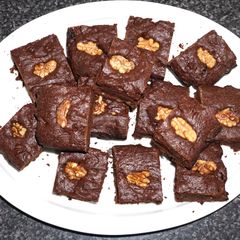 A picture of Brownies with raisins and walnuts.