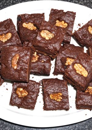 A picture of Brownies with raisins and walnuts.