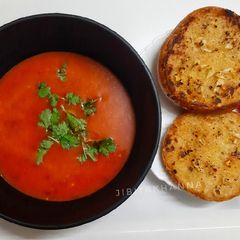 A picture of Tomato soup with Garlic Butter toasted bread.
