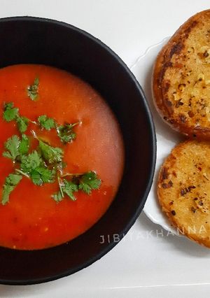 A picture of Tomato soup with Garlic Butter toasted bread.