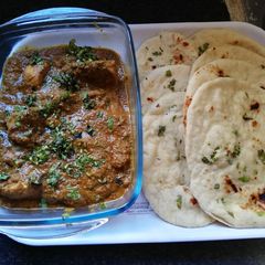 A picture of Chicken curry with tandoor roti.