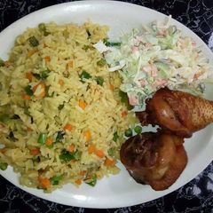 A picture of Fried rice with chicken and coleslaw.