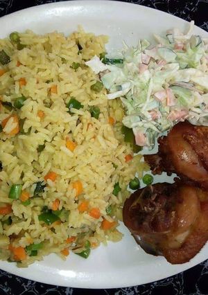 A picture of Fried rice with chicken and coleslaw.