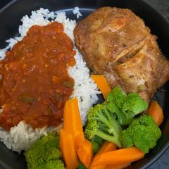 A picture of Grilled Chicken Thighs with Rice, Steamed Veggies & Tomato Gravy.