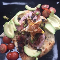 A picture of Flatbread, bacon, egg and avocado 🥑.