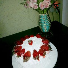 A picture of Whipped cream frosting with strawberry.