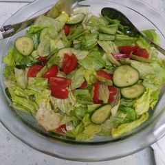 A picture of Lettuce cucumber tomatoes salad.