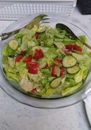 A picture of Lettuce cucumber tomatoes salad.