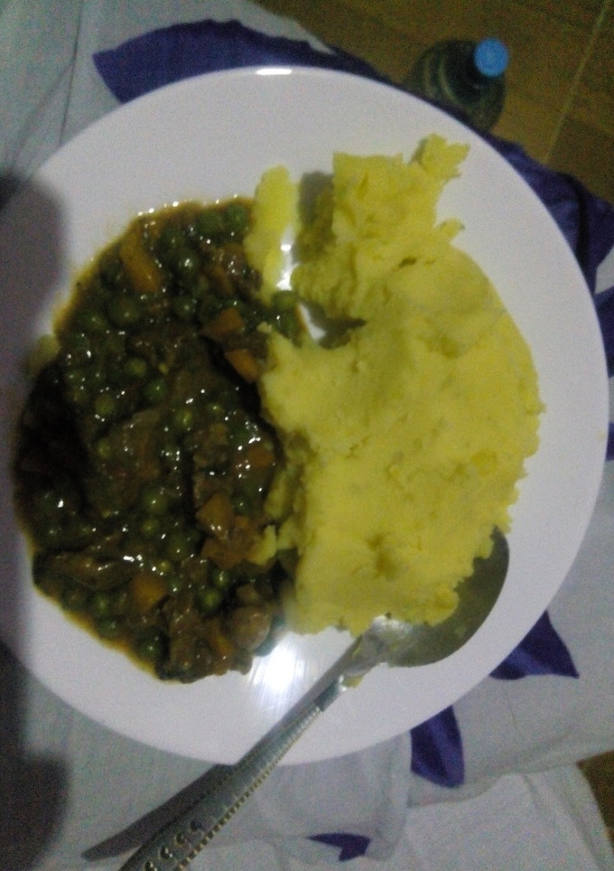 A picture of Mashed potatoes with beef and peas stew.
