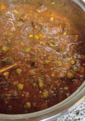 A picture of Beef stew with graden peas.