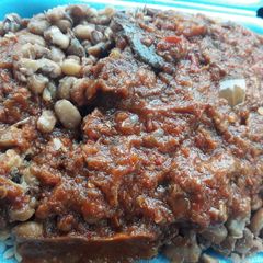 A picture of Brown beans with tomato paste.