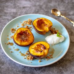 A picture of Roasted nectarines with ginger and honey crumble.