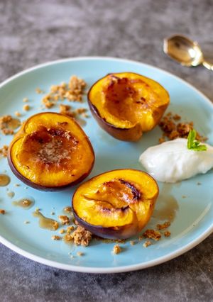 A picture of Roasted nectarines with ginger and honey crumble.