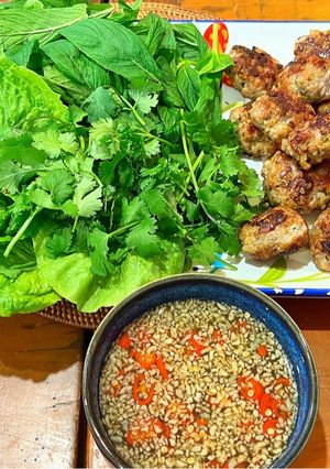 A picture of Meatballs with nouc cham, cucumber and mint.