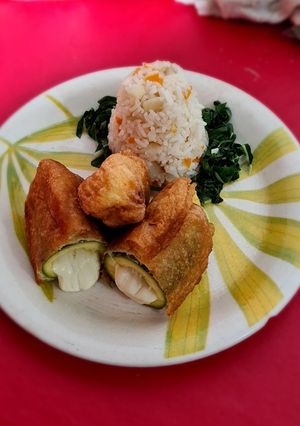 A picture of Battered Zucchini Stuffed with Quesillo and White Rice.