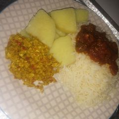 A picture of Rice, stew, yam, egg sauce.