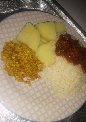 A picture of Rice, stew, yam, egg sauce.