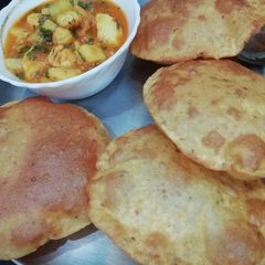 A picture of Alu bhaji and Puri.