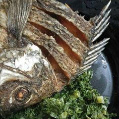 A picture of Fried fish with Kales.