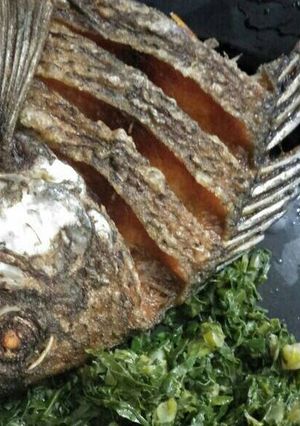 A picture of Fried fish with Kales.
