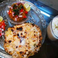 A picture of Amritsari naan chole with meethi lassi.