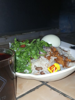 A picture of Rice and beans oil n pepper (Mein da yaji) with local salad.