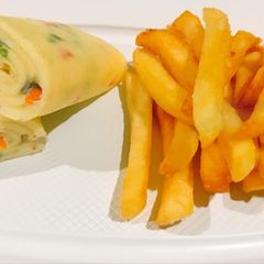 A picture of Rolled vegetable omelette and potato fries.