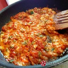 A picture of Bouyiourdi in a small frying pan.