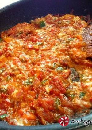 A picture of Bouyiourdi in a small frying pan.