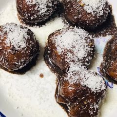 A picture of Baby doughnuts with coconut & chocolate topping.