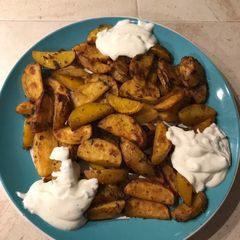 A picture of Healthy and delicious potatoes with sauce (vegetarian).