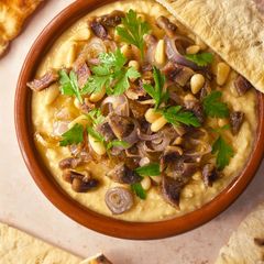 A picture of Hummus With Anchovies, Pine Nuts & Shallots.
