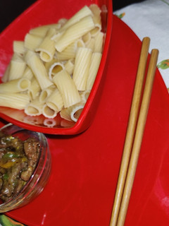A picture of Pasta and sherreded beef sauce.