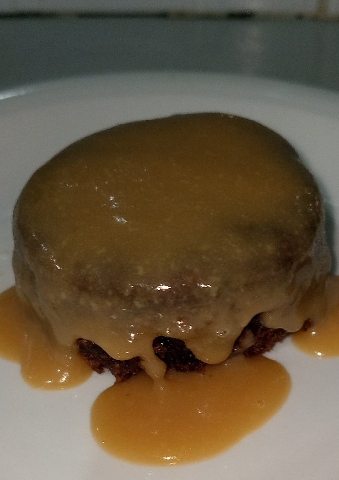 A picture of Dates pudding with sticky sauce.
