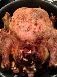 A picture of Whole Roasted Chicken, stuffed with apples and sausage.