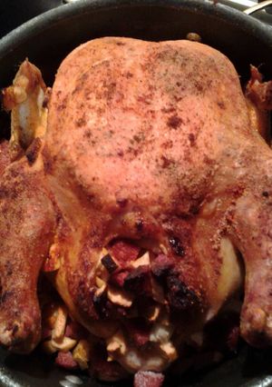 A picture of Whole Roasted Chicken, stuffed with apples and sausage.