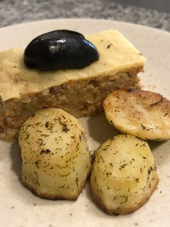 Una foto de Budín de zapallo italiano (zucchini) con parmesano gratinado y papas al eneldo