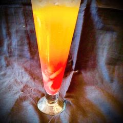 A picture of Colourful Lychee Sunrise layered Mocktail.