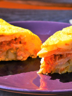 Una foto de Tortilla de patata rellena de chorizo y pasas